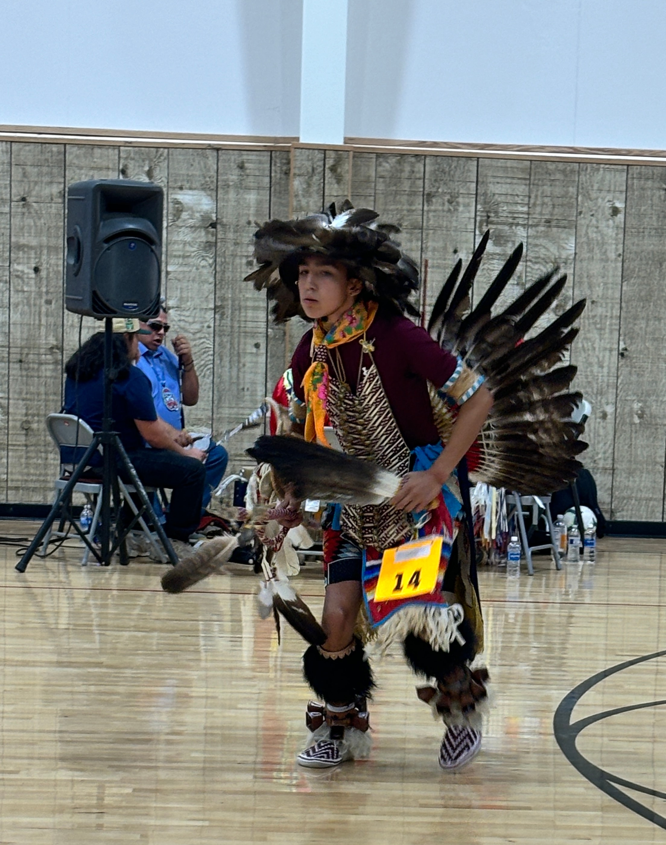 Dancer in traditional eagle regalia performing at a Modoc County powwow