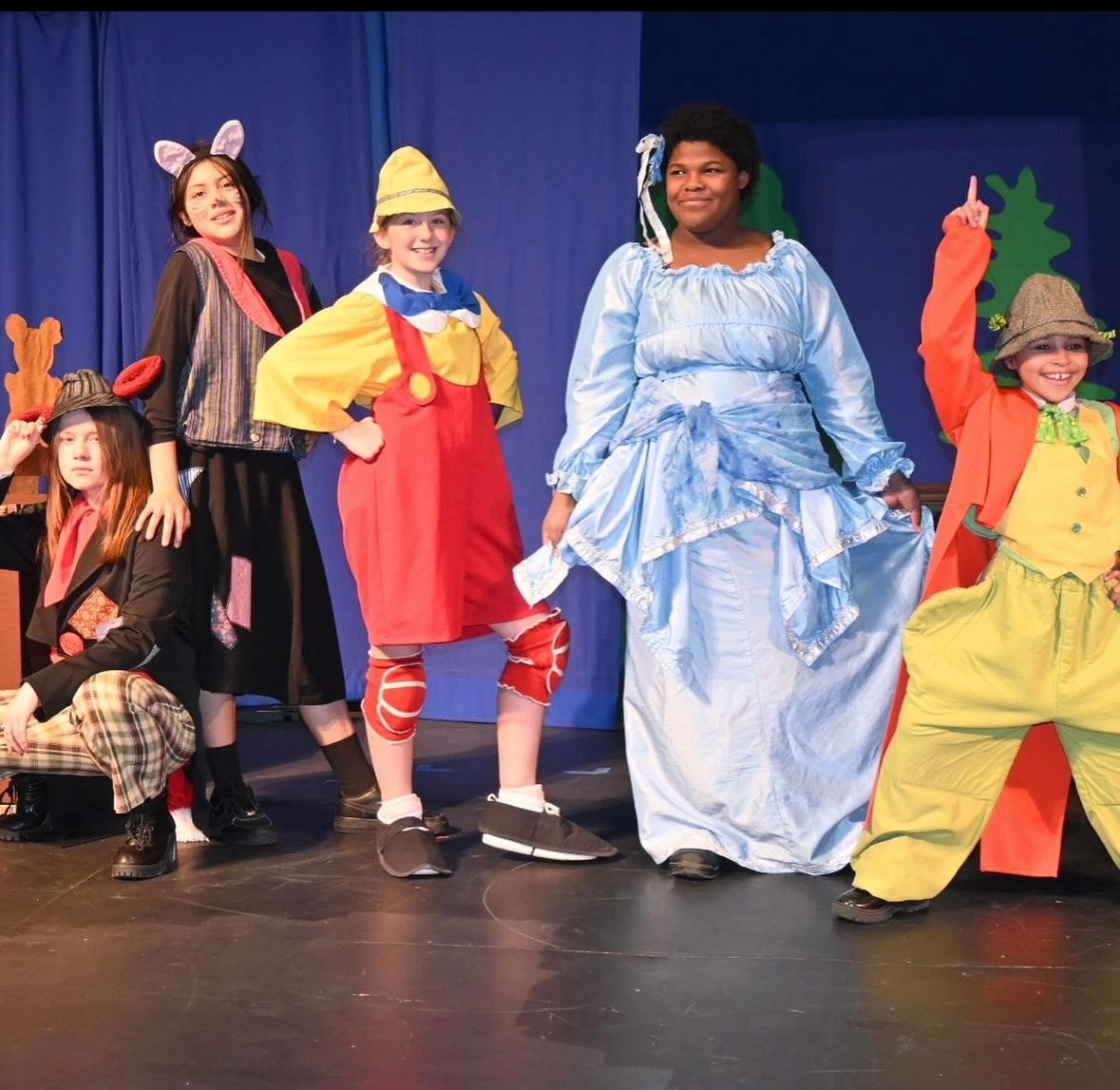 Children in colorful costumes performing on stage at Missoula Children's Theatre